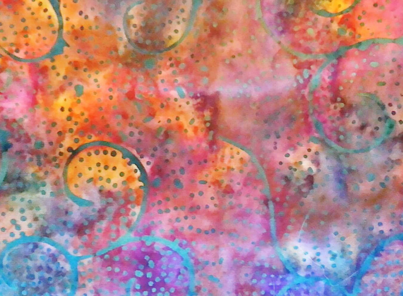 Orange, pink and purple batik fabric with dot pattern