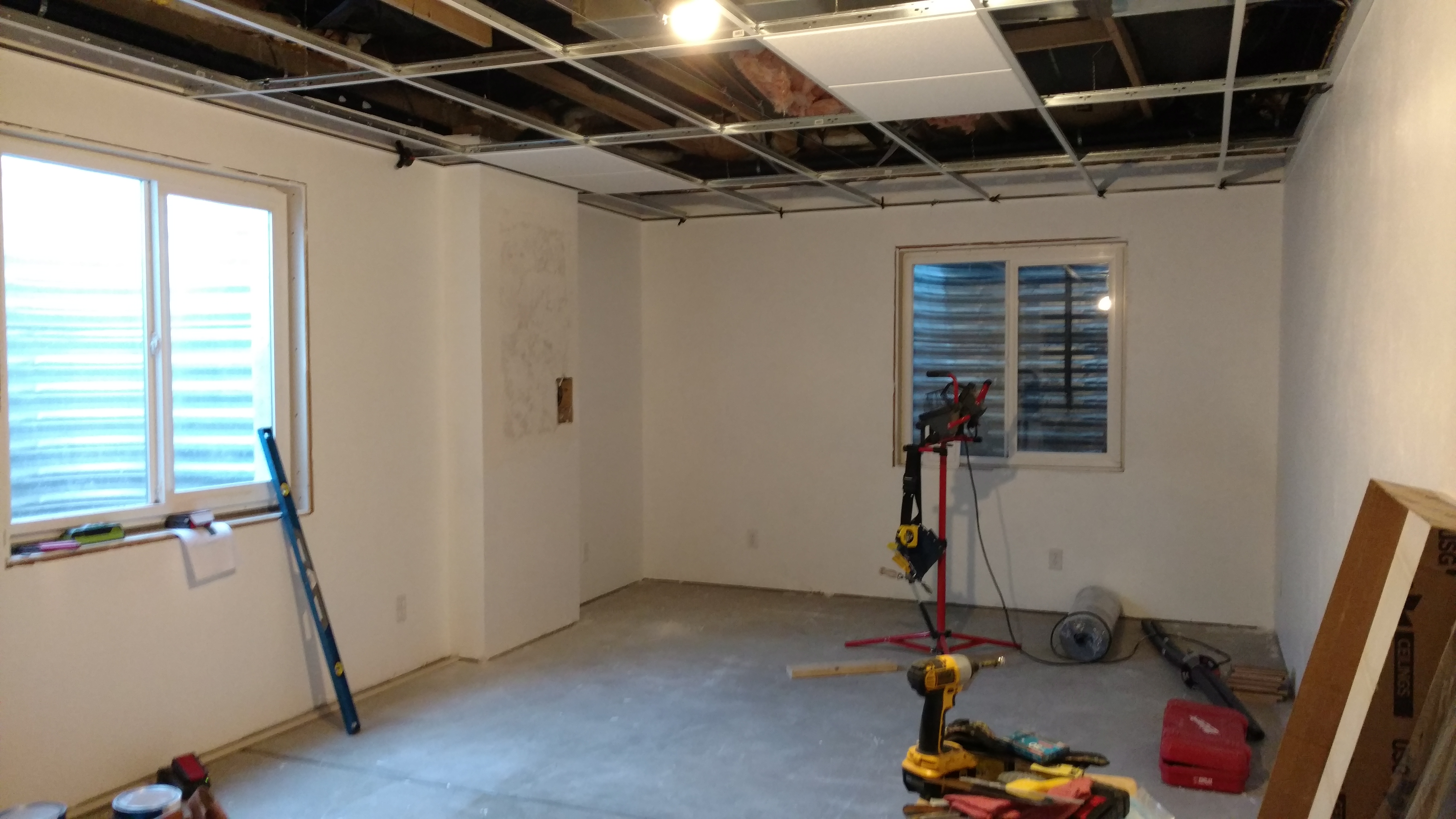 Basement room under renovation with new drywall and windows