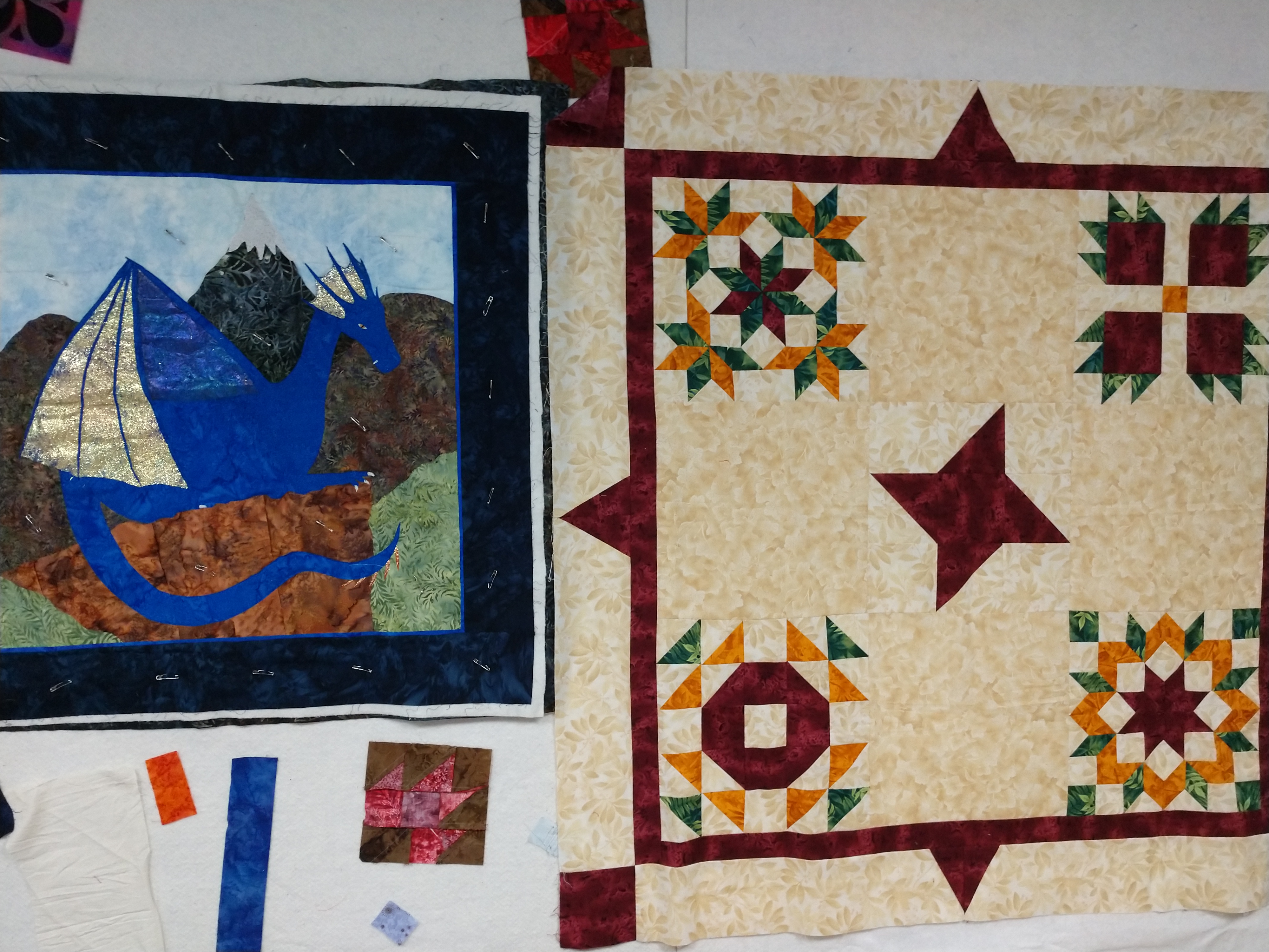 Quilts with appliqued sailboat and pieced star blocks