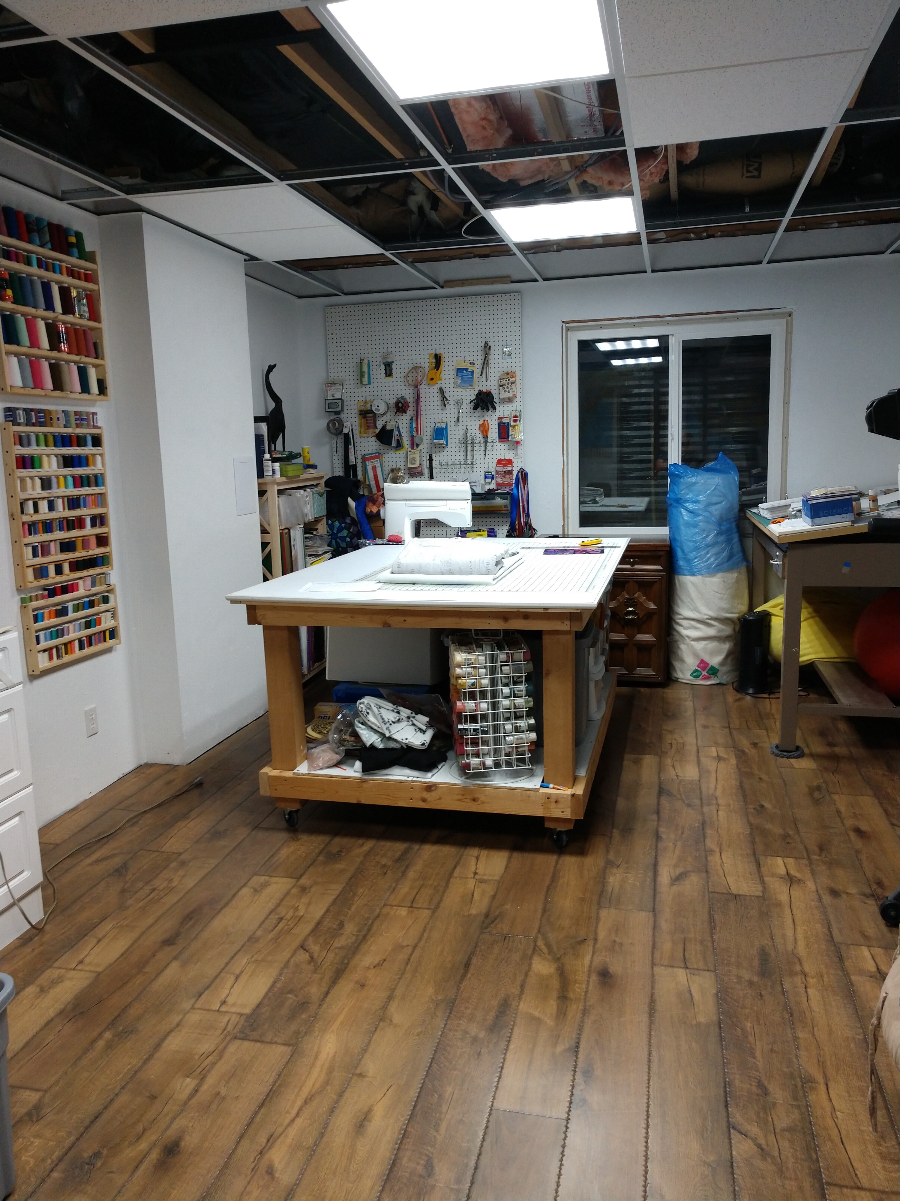 Sewing studio with a large cutting table and wood floor