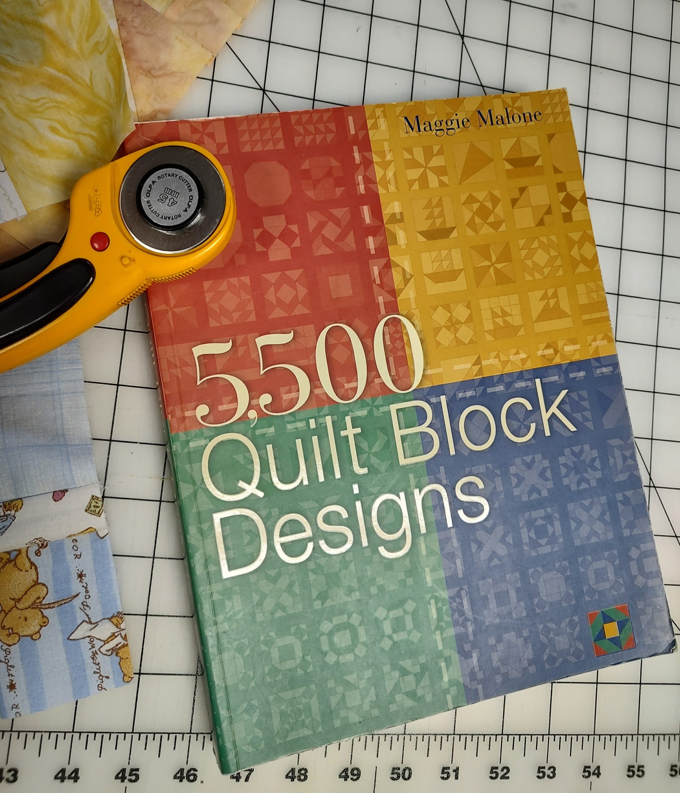 5500 Quilt Block Designs book with rotary cutter on cutting mat